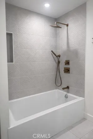 a bathroom with a bath tub with a shower