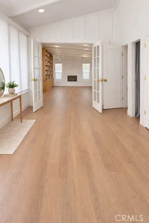a view of a livingroom with wooden floor and staircase