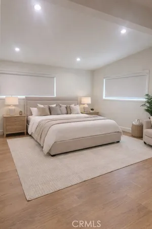a bedroom with a bed and a night stand