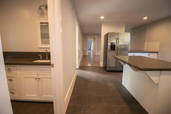 a kitchen with stainless steel appliances granite countertop a sink and a refrigerator