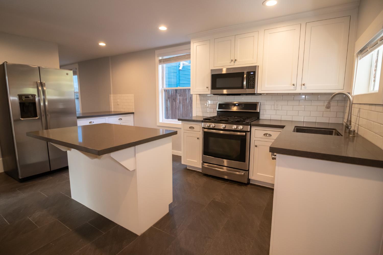 1317 D Street Sacramento, CA 95814 - Photo 6 of 16 a kitchen with stainless steel appliances granite countertop a stove a sink and a refrigerator