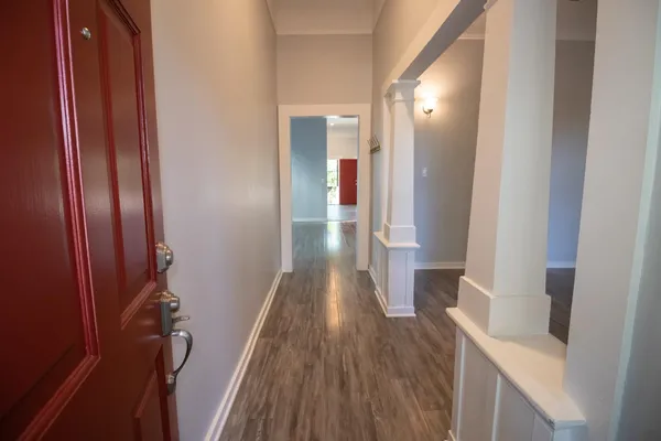 a view of hallway with wooden floor