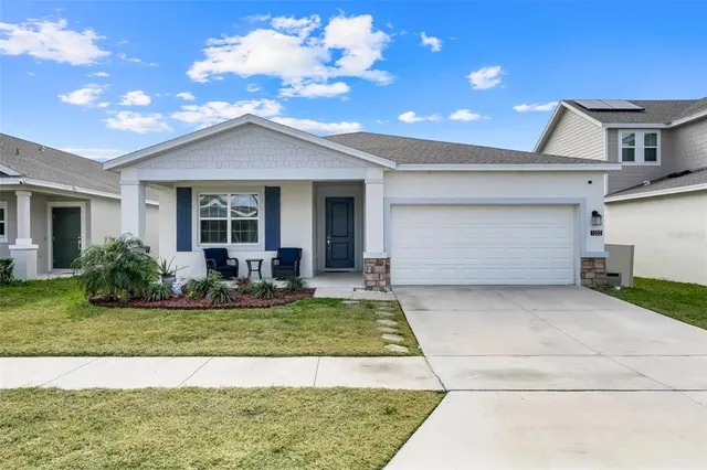 a view of a house with a yard and garage