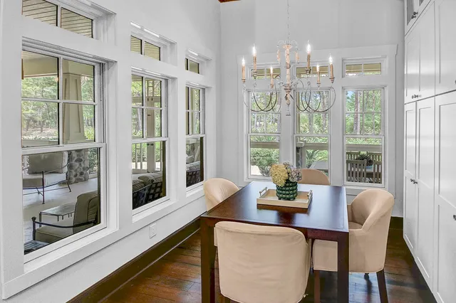 a dining room with furniture water view and large windows