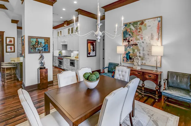 a view of a dining room with furniture a rug and wooden floor