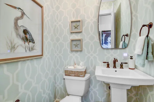 a bathroom with a sink and a mirror with painted walls