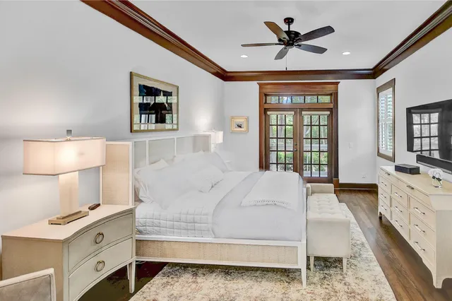 a spacious bedroom with a bed and a chandelier