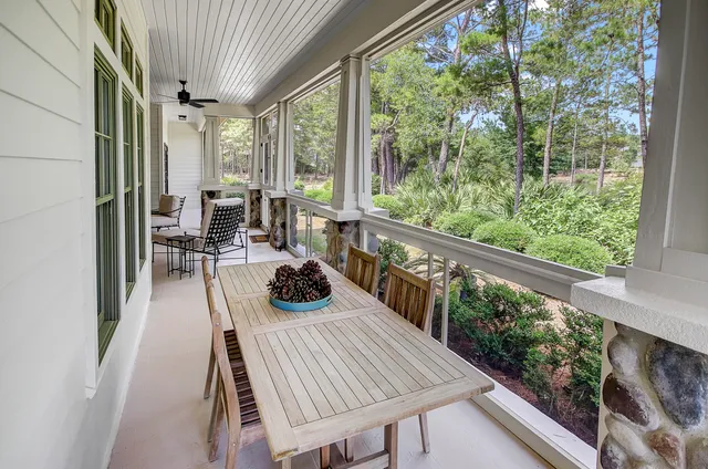 a view of a patio with table and chairs and wooden floor