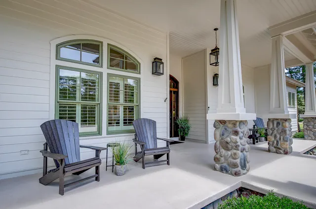a living room with furniture and floor to ceiling windows