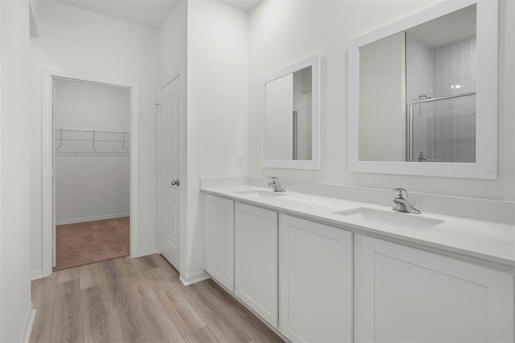 13348 Tula Loop Astatula, FL 34705 - Photo 14 of 22 a bathroom with a sink and a mirror