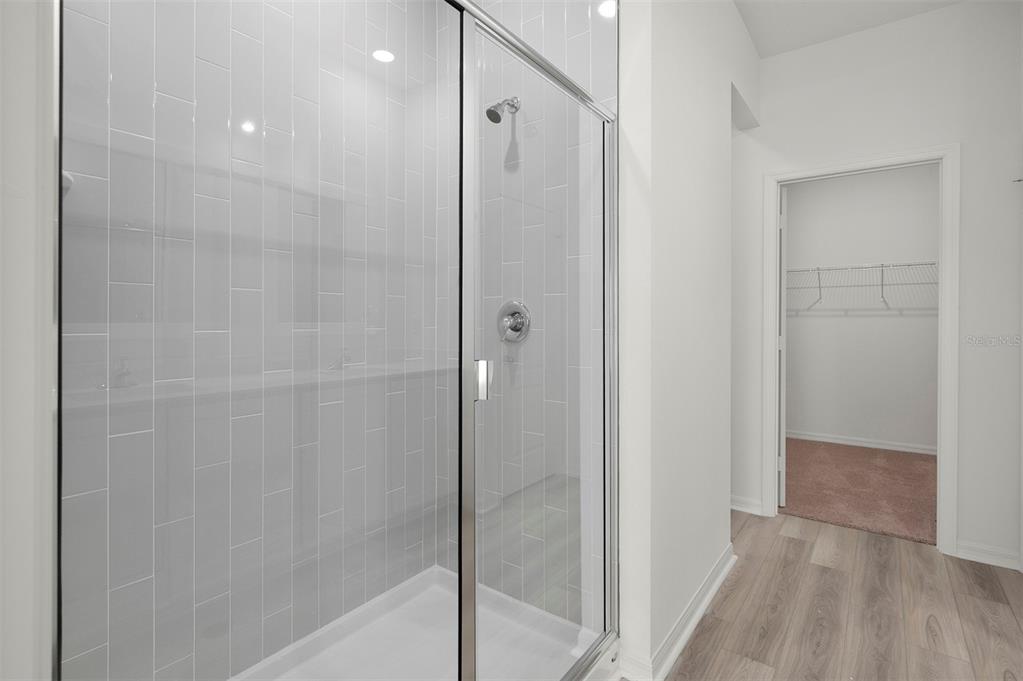 13348 Tula Loop Astatula, FL 34705 - Photo 15 of 22 a bathroom with a shower and a glass door