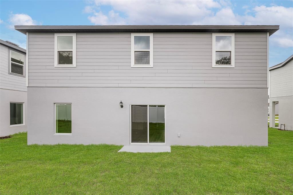 13348 Tula Loop Astatula, FL 34705 - Photo 20 of 22 a front view of a house with a yard