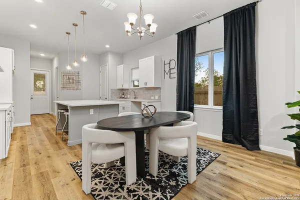 a view of a dining room with furniture and wooden floor