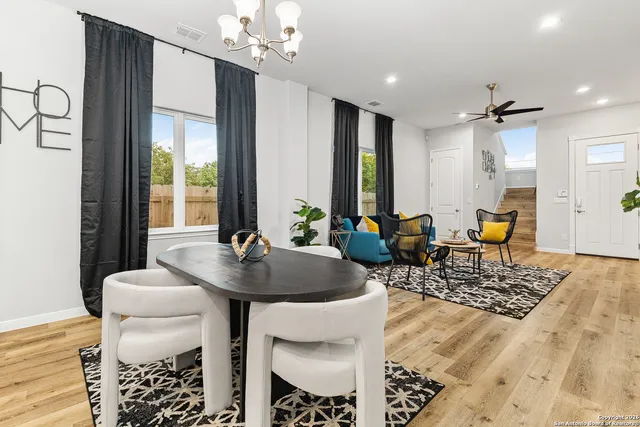 a living room with furniture a chandelier and a table