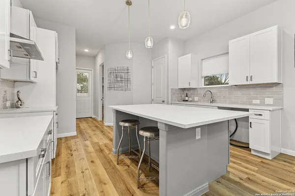 a kitchen with a sink appliances and cabinets