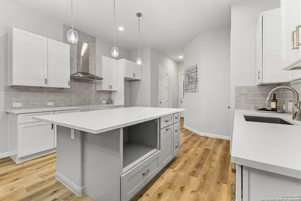 a kitchen with a sink stainless steel appliances and cabinets