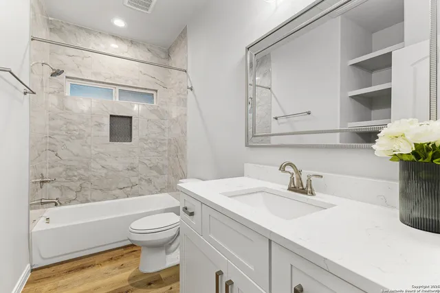 a bathroom with a sink toilet and shower