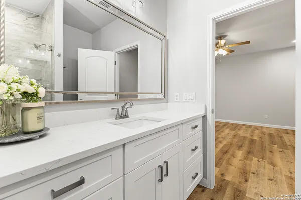 a bathroom with a sink a vanity and a mirror