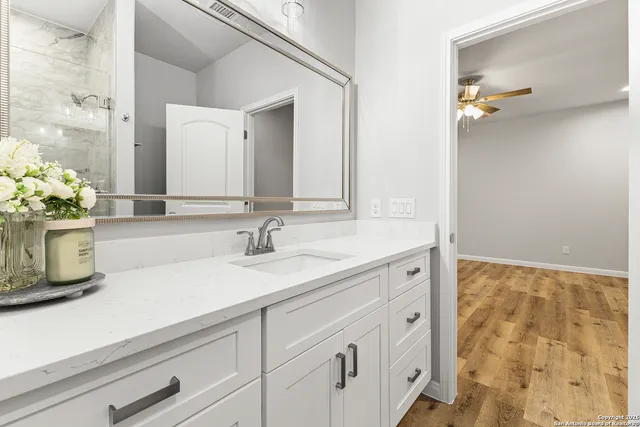 a bathroom with a sink a vanity and a mirror