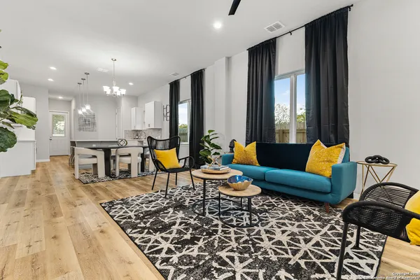a living room with furniture a rug and a chandelier