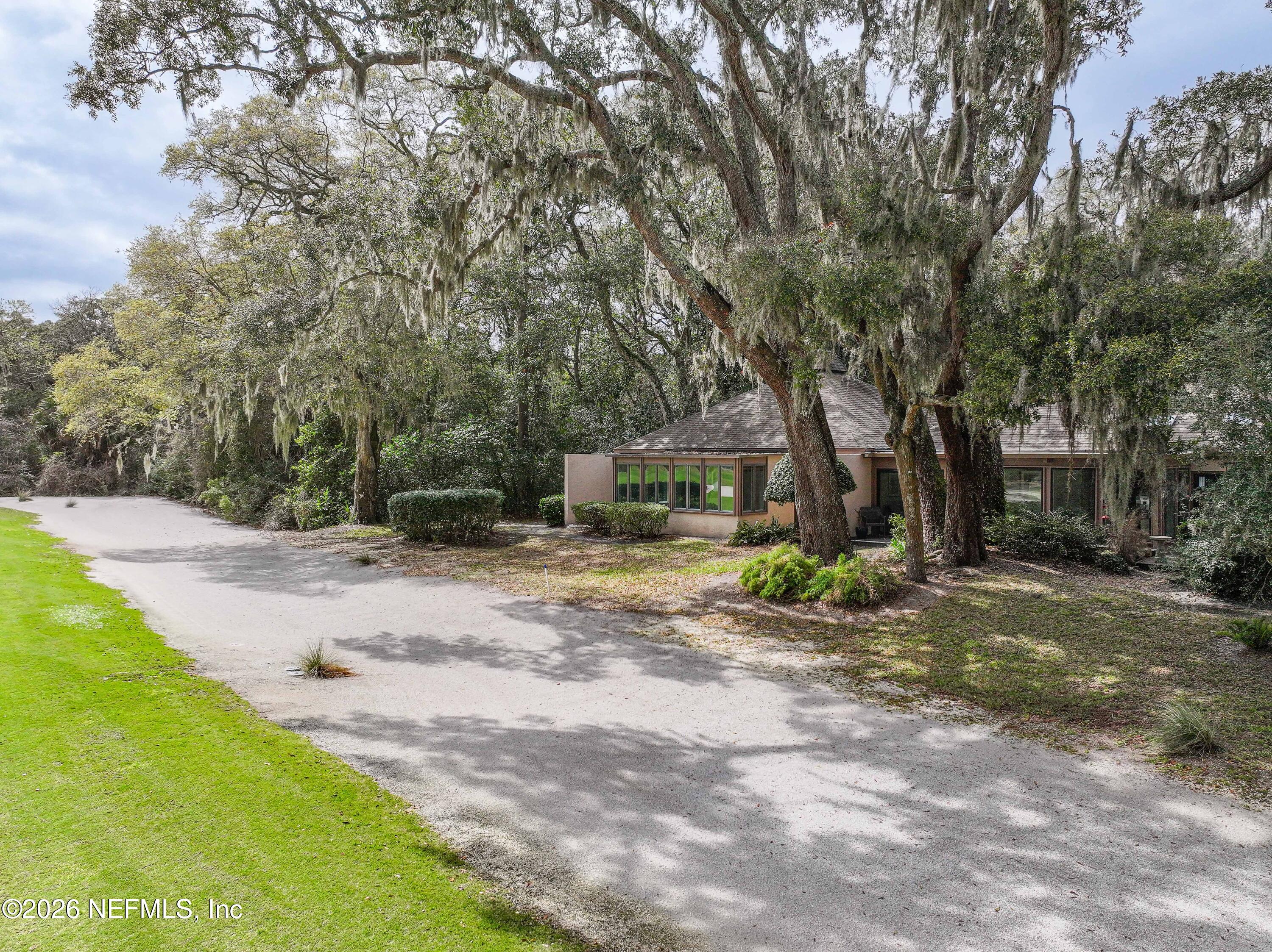 3301 Sea Marsh Road Fernandina Beach, FL 32034 - Photo 36 of 41 a view of a yard with plants and trees