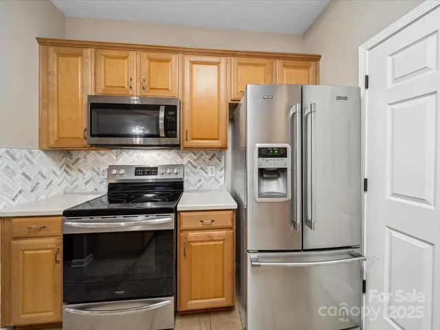 a kitchen with a refrigerator stove and microwave