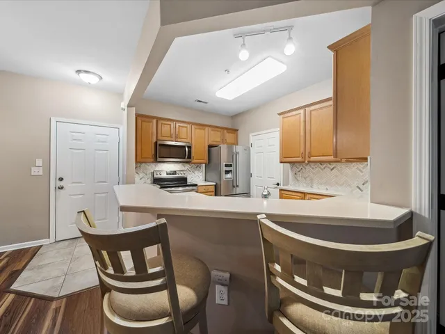 a kitchen with a dining table and chairs