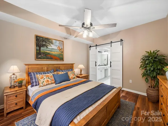 a bedroom with a large bed and a chandelier