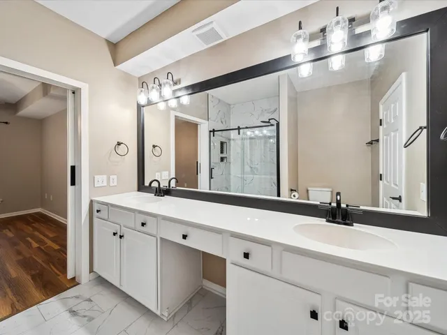 a bathroom with a double vanity sink and a mirror