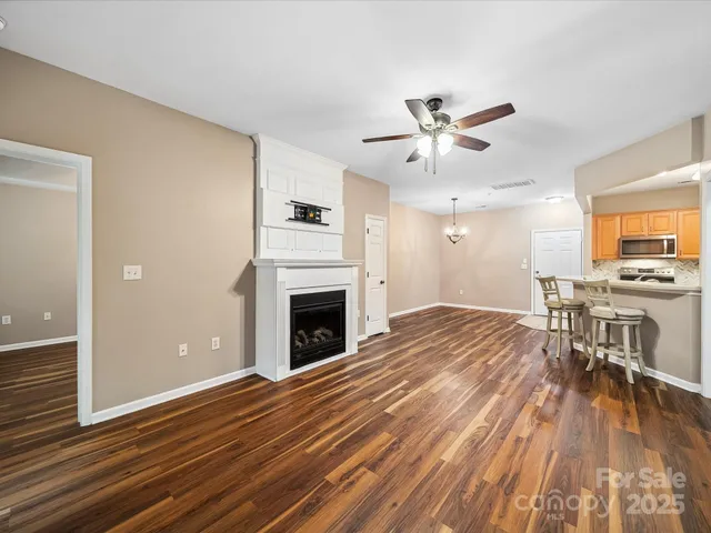 a view of livingroom with hardwood floor and a ceiling fan