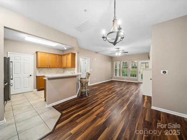 a view of a kitchen with wooden floor and windows