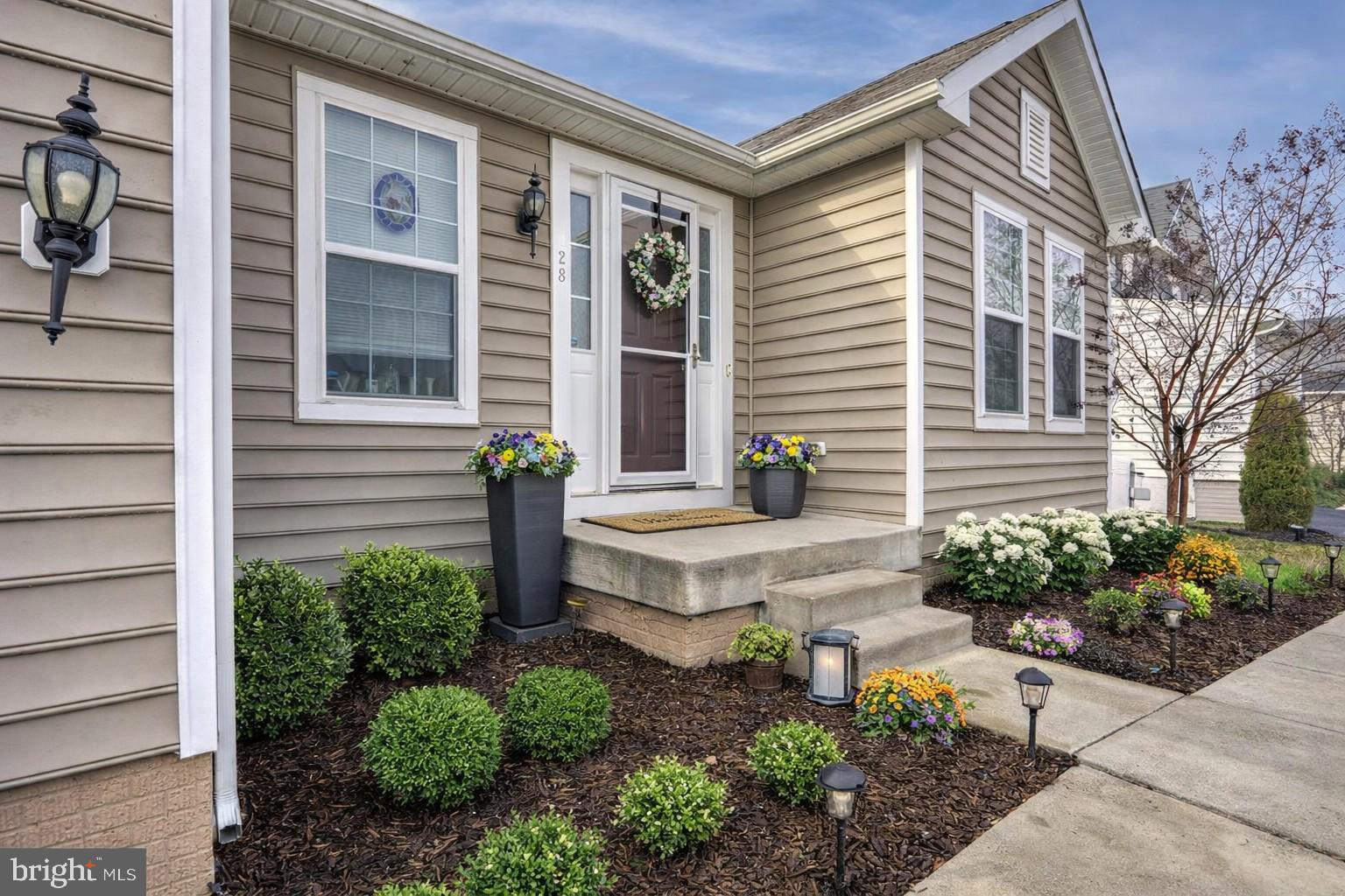 128 Sparkling Brook Road Ranson, WV 25438 - Photo 49 of 57 Charming entryway with vibrant blooms.