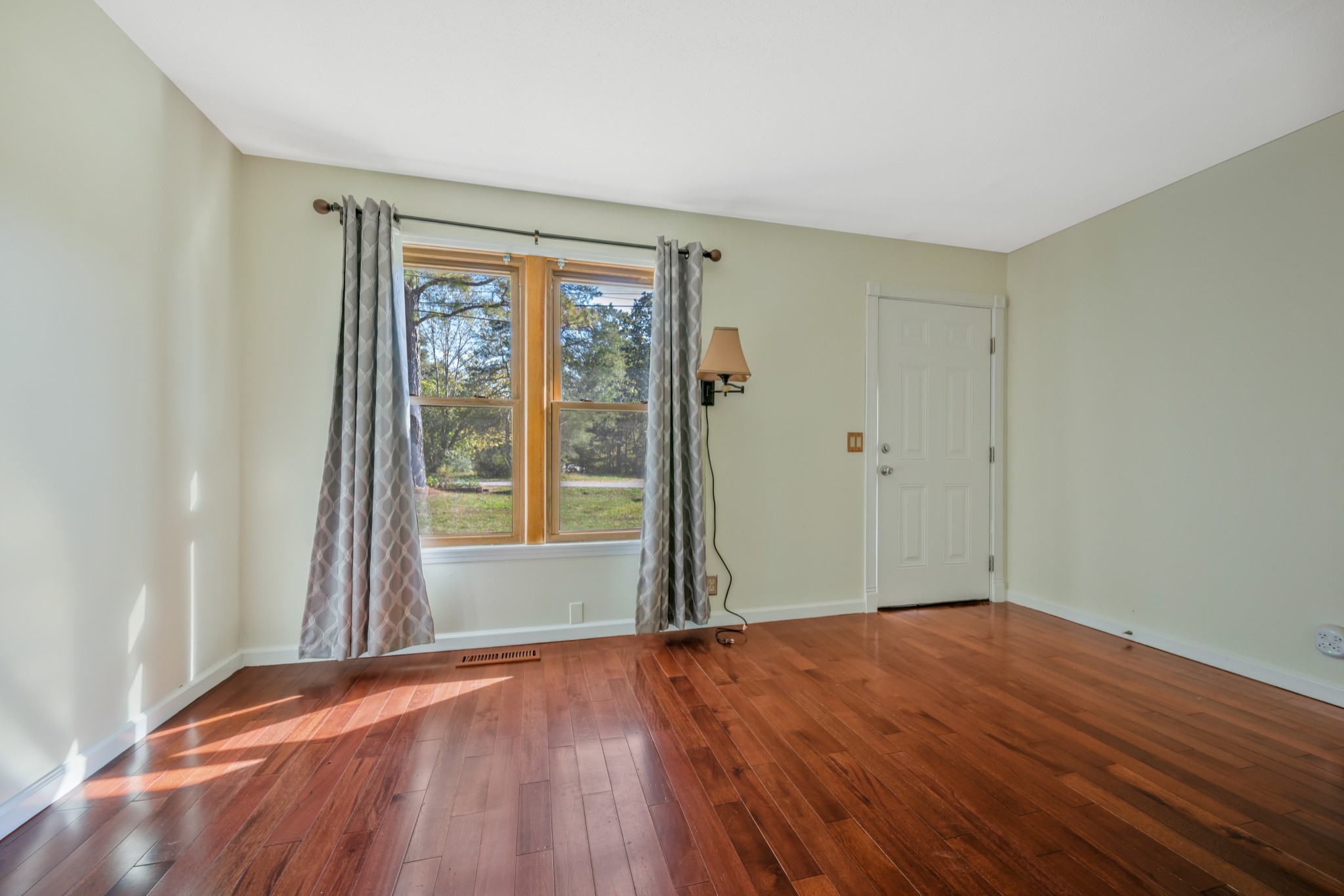 3904 Cedar Street Centerville, TN 37033 - Photo 11 of 18 an empty room with wooden floor and windows
