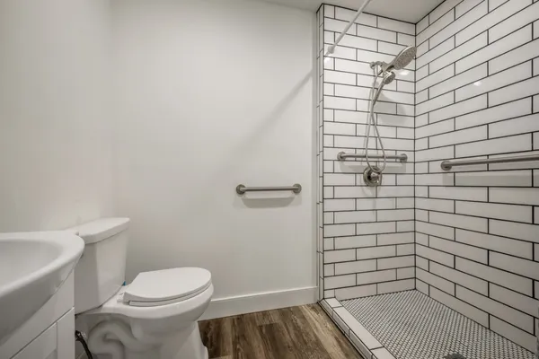 a bathroom with a toilet and a shower
