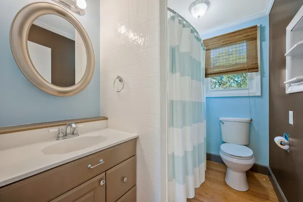 a bathroom with a toilet a sink and a mirror