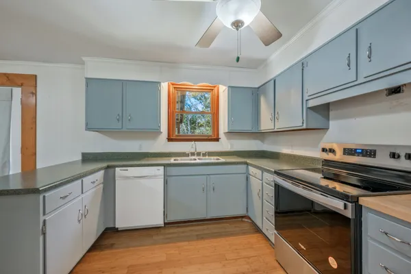 a kitchen with a sink stove and cabinets