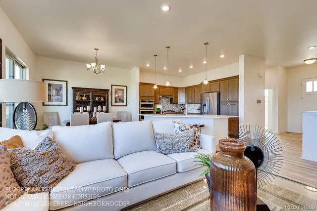 a living room with furniture and a view of kitchen