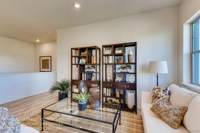 a living room with furniture and a book shelf