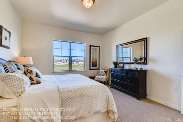 a bedroom with a bed and a dresser next to a window