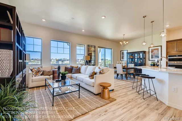 a living room with fireplace furniture and a wooden floor