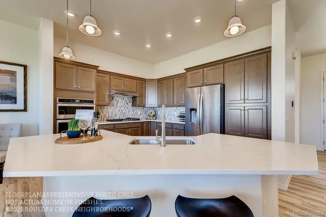 a kitchen with stainless steel appliances a refrigerator sink and microwave