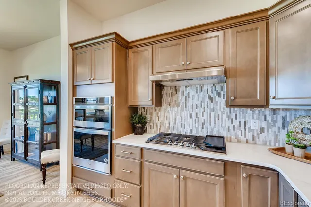 a kitchen with stainless steel appliances a stove a sink and cabinets