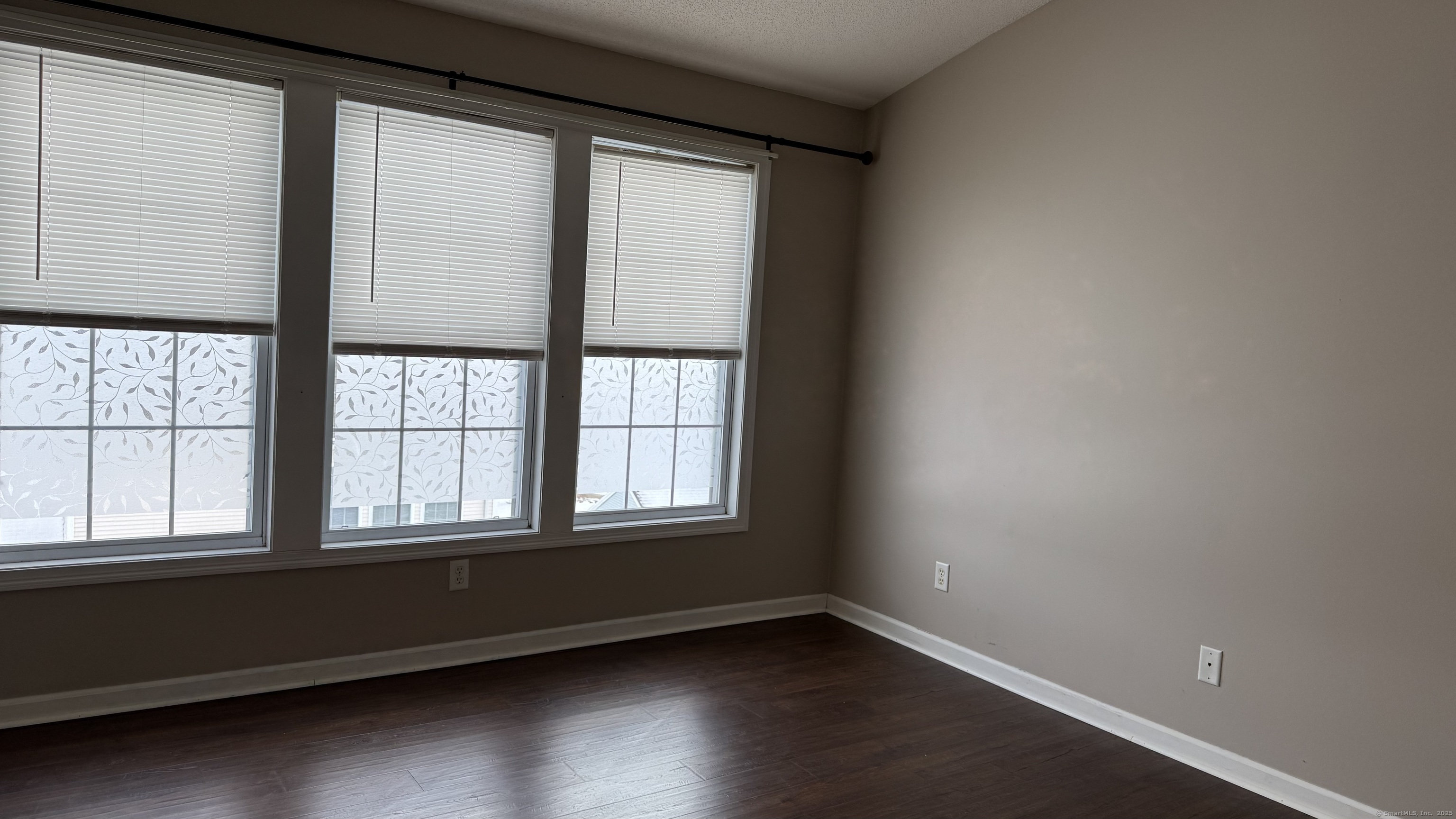 40 Mountain Laurel Way, Unit 40 Suffield, CT 06078 - Photo 11 of 16 an empty room with wooden floor and windows