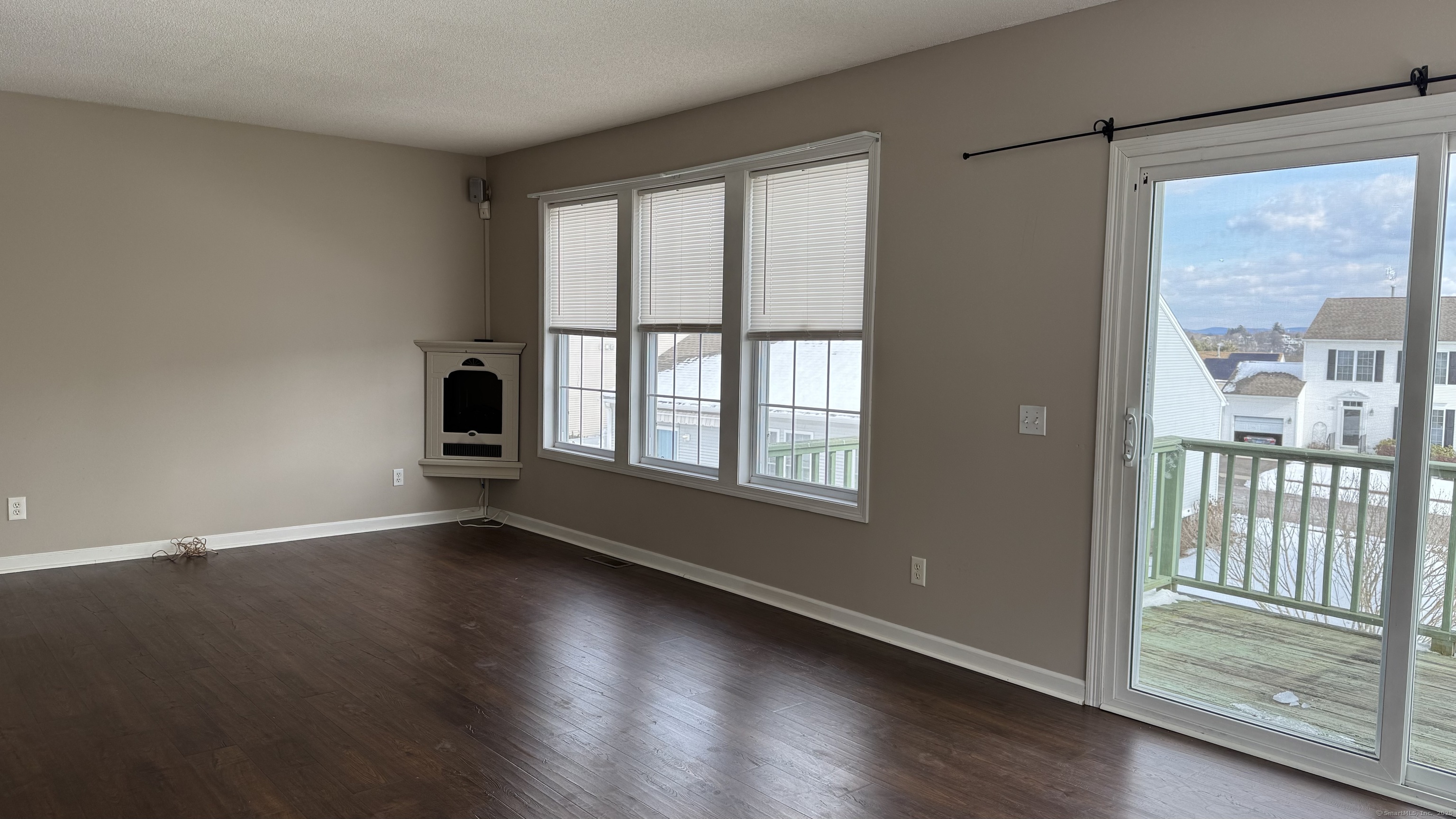 40 Mountain Laurel Way, Unit 40 Suffield, CT 06078 - Photo 6 of 16 a view of an empty room with wooden floor and a window