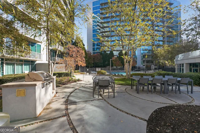 a view of a patio with dining table and chairs