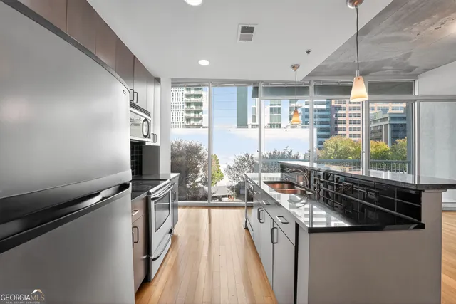 a kitchen with stainless steel appliances a sink stove and cabinets