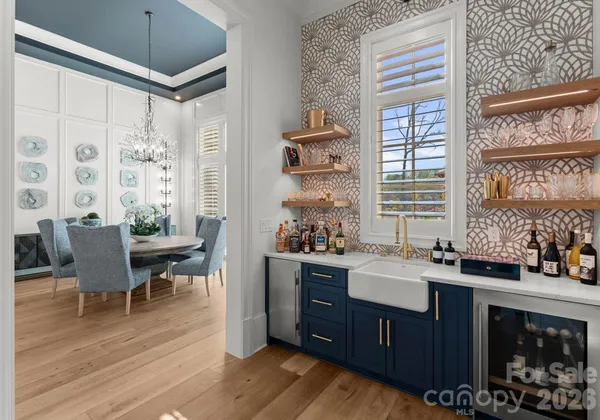a spacious bathroom with a double vanity sink a mirror and a shower