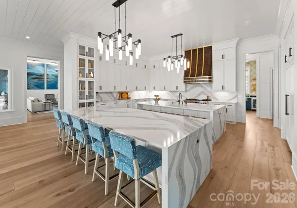 a kitchen with stainless steel appliances a kitchen island hardwood floor and breakfast area