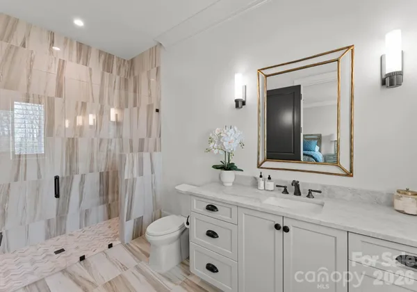 a bathroom with a double vanity sink mirror and shower