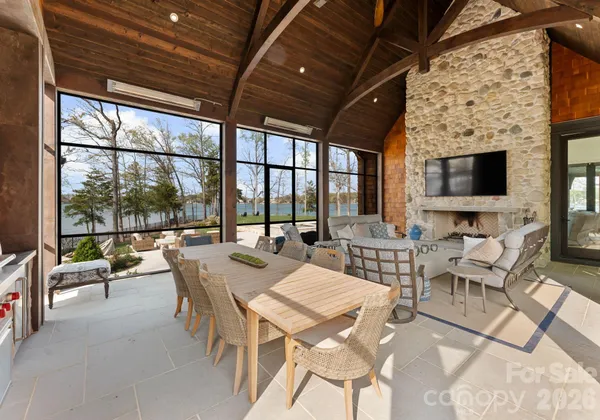 a view of a dining room with furniture wooden floor and a fireplace